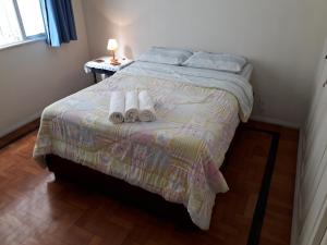 a bedroom with a bed with two towels on it at Great Moments Copacabana in Rio de Janeiro