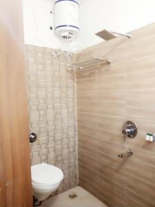 a bathroom with a toilet and a shower stall at HOTEL RUDRAKSHA INN in Deoghar