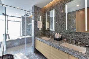 a bathroom with two sinks and a shower at The Clouds Apartment in Shenzhen