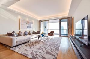 a living room with a couch and a table at The Clouds Apartment in Shenzhen