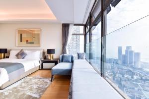 a bedroom with a bed and a large window at The Clouds Apartment in Shenzhen