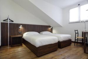 1 dormitorio con 2 camas, mesa y escritorio en My Bed, en Milán