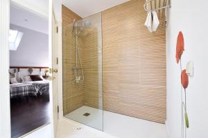 a shower with a glass door in a bathroom at Villa Antumalal B&B in Málaga