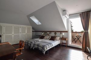 a bedroom with a bed and a large window at Villa Antumalal B&B in Málaga