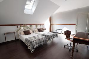 a bedroom with two beds and a desk and a piano at Villa Antumalal B&B in Málaga