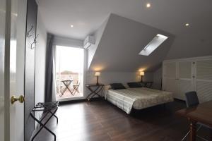 a bedroom with a bed and a large window at Villa Antumalal B&B in Málaga