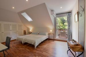 a bedroom with a bed and a large window at Villa Antumalal B&B in Málaga