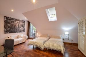a living room with two beds and a couch at Villa Antumalal B&B in Málaga