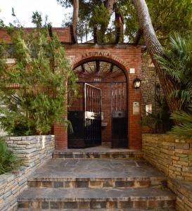 an entrance to a brick building with a gate at Villa Antumalal B&B in Málaga