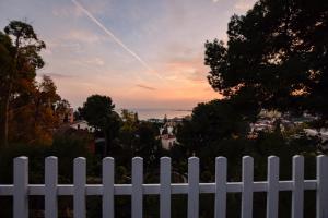 a white fence with a view of the ocean at Villa Antumalal B&B in Málaga