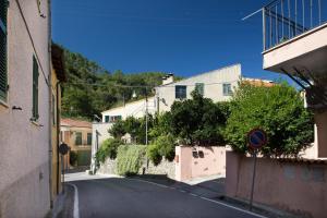 an empty street in a village with buildings at da Barbara in Orco Feglino