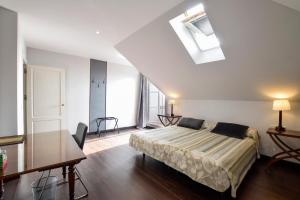 a bedroom with a bed and a skylight at Villa Antumalal B&B in Málaga