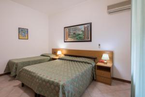 Postel nebo postele na pokoji v ubytování Hotel Astor Victoria