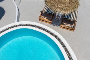 an overhead view of a pool with a table and chairs at Summer Lovers Villa in Akrotiri +59 photos