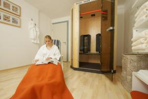 a woman in an orange skirt reading a book at Berg-Cafe in Kempten