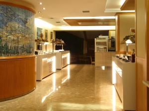 a large room with a kitchen with white appliances at Hotel Guillem & Spa in Encamp