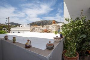 a group of vases sitting on the ledge of a balcony at Hotel Sofia in Apollonia