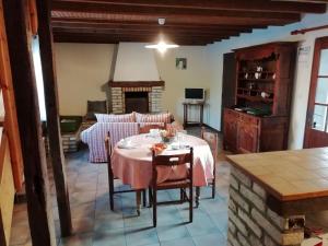 a dining room with a table and a kitchen at Holiday home in Quend Plage les Pins with pool in Quend