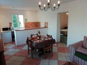 a kitchen and dining room with a table and chairs at Holiday home with swimming pool in Quend