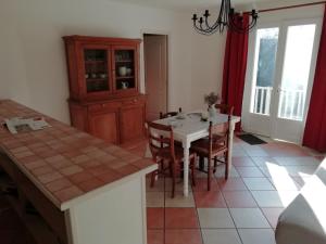 a kitchen with a table and chairs and a dining room at Cosy flat with pool in Quend Plage les Pins in Quend