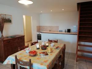 a kitchen with a table with fruit on it at Holiday home with swimming pool in Quend