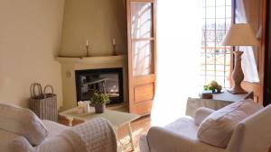 a living room with a couch and a fireplace at Mas del Mar in Sant Pere Pescador