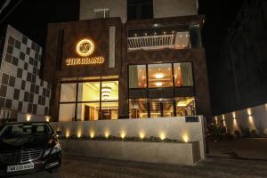 a car parked in front of a building at night at The Grand in Āsansol