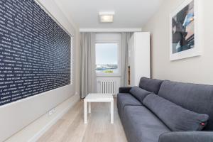 a living room with a couch and a table at Premium apartment with a port view by Renters in Świnoujście