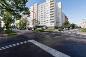 an empty city street with a large white building at Premium apartment with a port view by Renters in Świnoujście