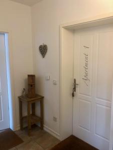 a white door with a heart on the wall at Villa Schaller - Apartment in Krumpendorf am Wörthersee