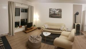 a living room with a couch and a table at Ferienwohnung FERRUM in Korbach
