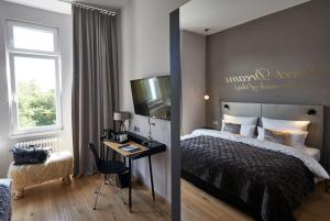 a bedroom with a bed and a desk at LIONO BoutiqueHotel in Goslar