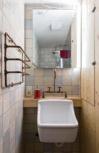 a bathroom with a white toilet and a sink at Romantic 16th century workers house in Ghent