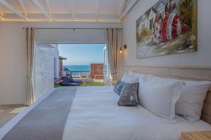 a bedroom with a bed with a view of the ocean at Seeplaas Guesthouse in Groot Brak Rivier