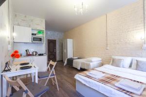a bedroom with a bed and a desk in a room at Guests Love on Kazanskaya in Saint Petersburg