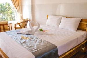 Postel nebo postele na pokoji v ubytování Mui Ne Beach Hotel