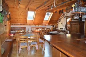 a kitchen and dining room with a table and chairs at Penzion 409 in Horní Branná