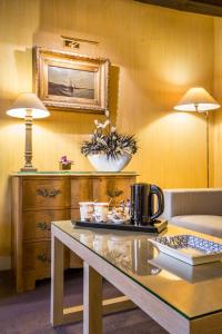 a room with a table with a coffee maker on it at Hôtel la Residence Du Berry in Versailles