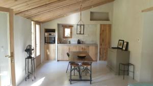 a kitchen with a table and chairs in a room at La petite maison in Aix-en-Provence +7 photos