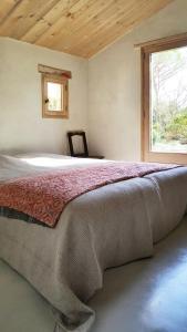 a bedroom with a large bed with a window at La petite maison in Aix-en-Provence