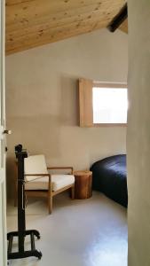 a bedroom with a bed and a chair at La petite maison in Aix-en-Provence