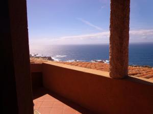 a view of the ocean from a hotel balcony at Una terrazza in Paradiso in Costa Paradiso