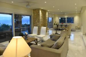 a living room with a couch and chairs and a table at Villa Gournes Resort in Porto Heli