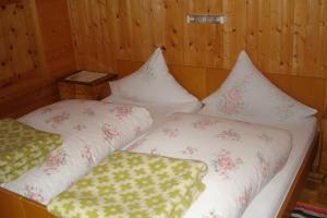 a bedroom with two beds with pillows on them at Ausserwalderhof in Innervillgraten