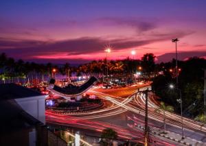 a night view of a busy city street with traffic at Films House Hostel in Bangsaen