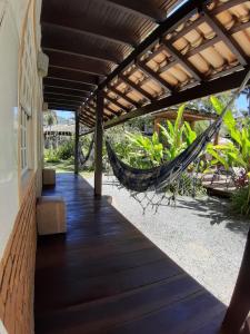 a hammock on the porch of a house at Atobá Villas in Paraty