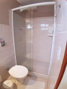 a bathroom with a toilet and a glass shower at Atobá Villas in Paraty