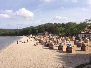 a group of beach chairs on a sandy beach at Ferienwohnung Heikendorf in Heikendorf