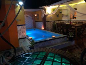 een zwembad in het midden van een kamer met een tafel bij Ca L'Isabel in Villanueva de los Castillejos