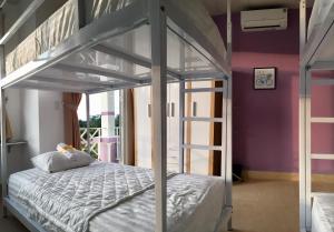 Giường trong phòng chung tại Purple Place Homestay Phu Quoc